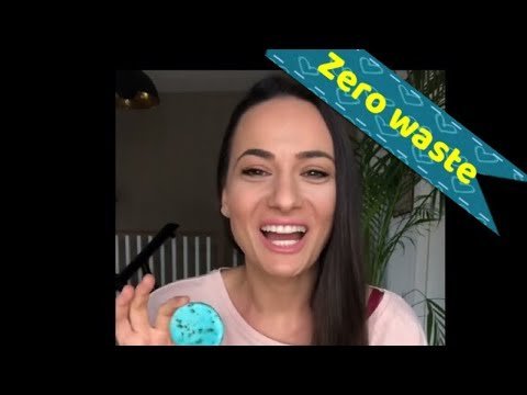 Smiling woman holding a solid shampoo, promoting zero waste.