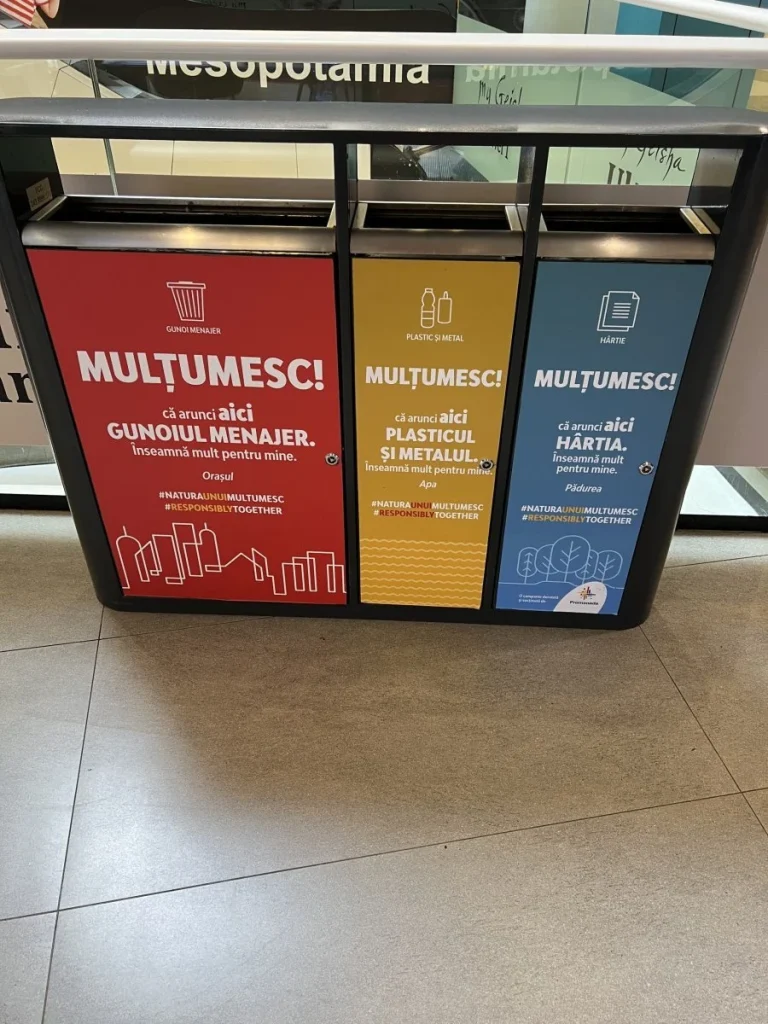 Recycling bins with messages about selective waste collection.