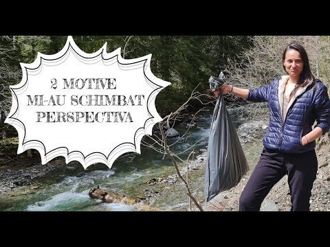 Woman picking up trash by a river, holding a plastic bag.