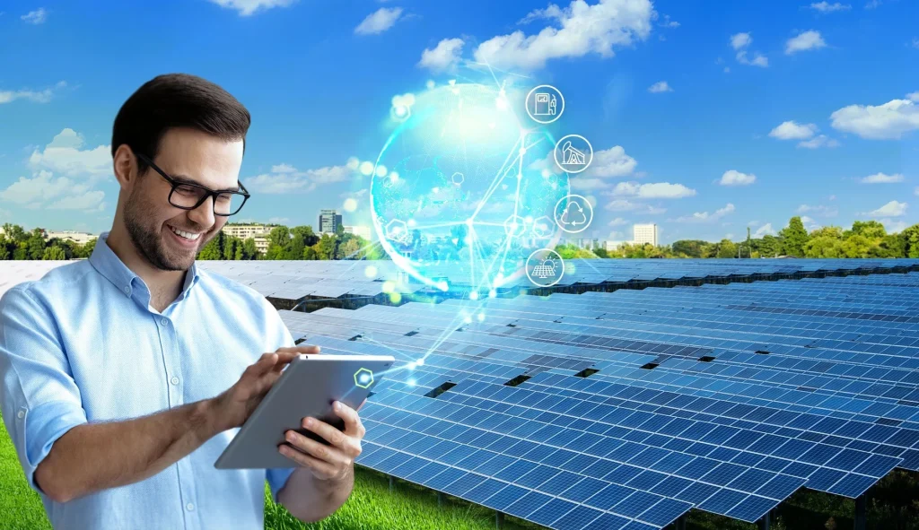 Smiling man using a tablet near solar panels, analyzing sustainability data.