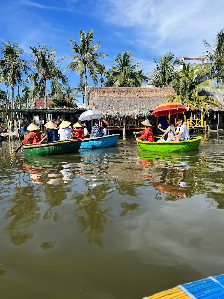 Tourists on water in colorful boats, enjoying the tropical scenery in Vietnam.