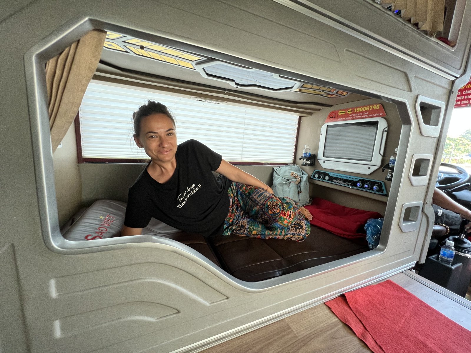 Woman relaxing in a transport compartment in Vietnam, promoting sustainable tourism.