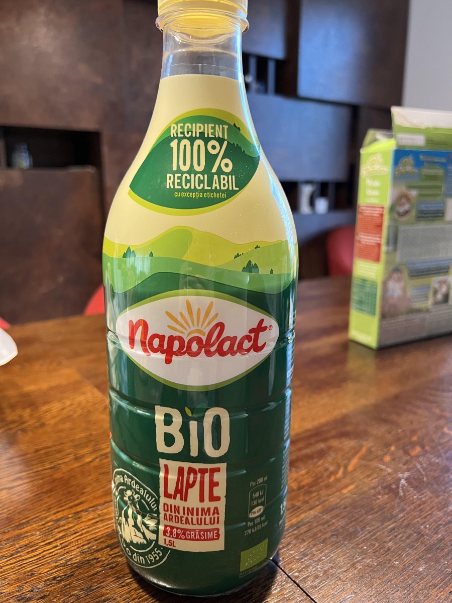 Napolact milk bottle labeled '100% recyclable container', highlighting eco-friendly packaging.