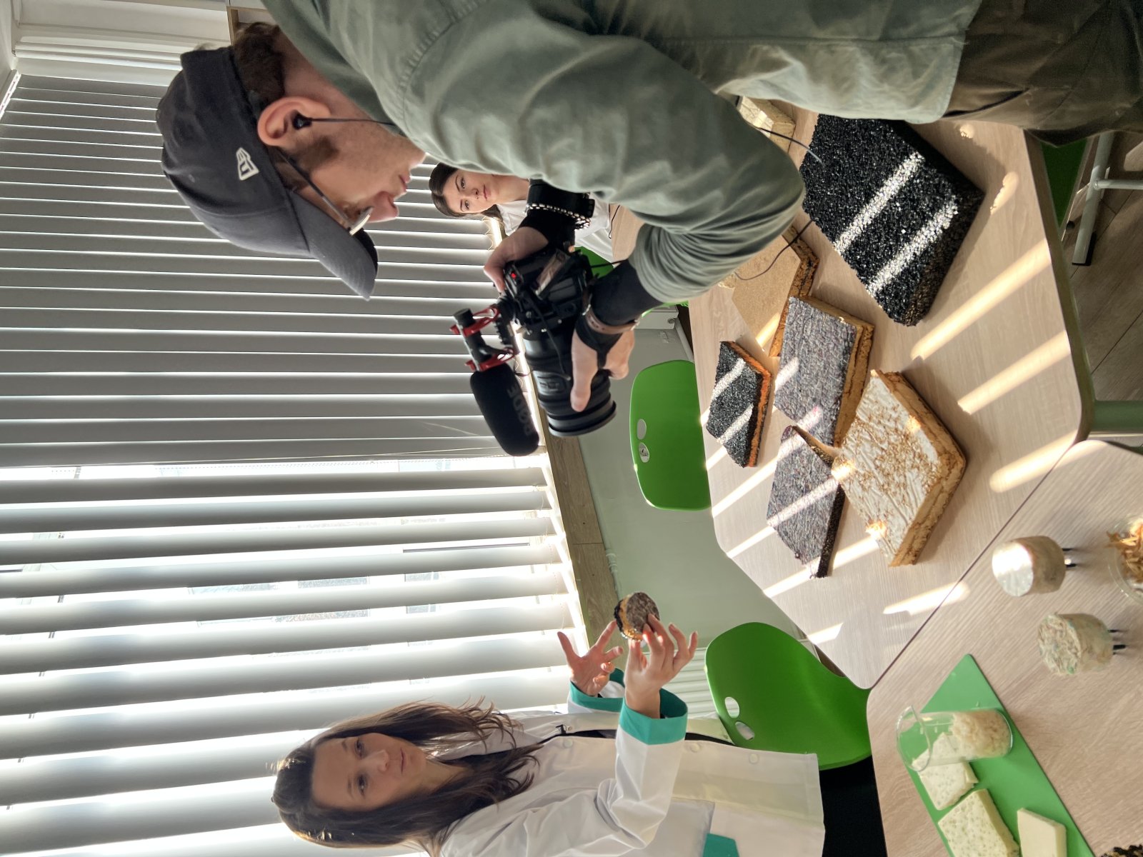 A presentation of innovative materials from waste, with an expert and a cameraman.