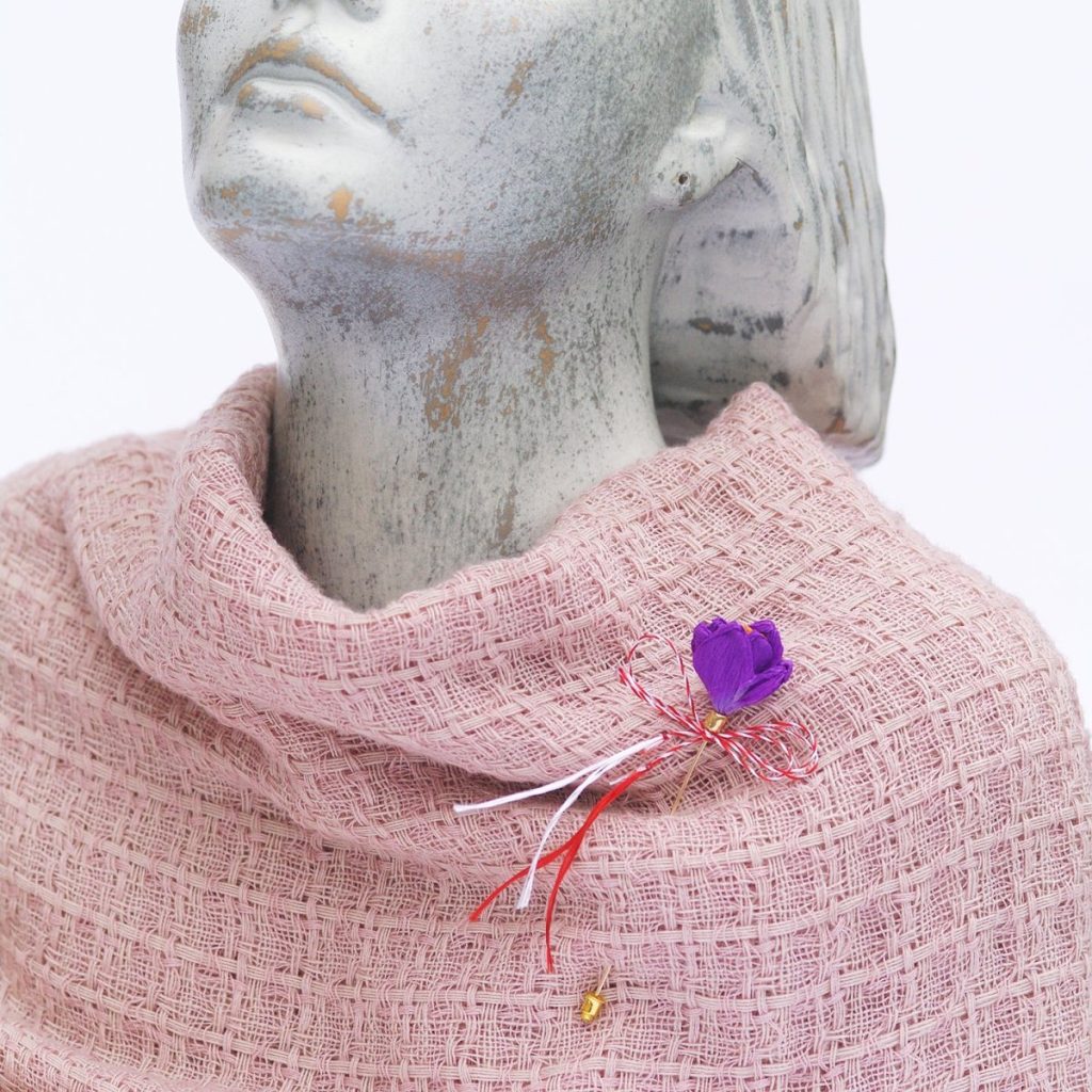 Eco-friendly handmade mărțișor with a purple flower on a pink scarf.
